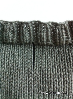 En tråd markerer ryggen af sweateren